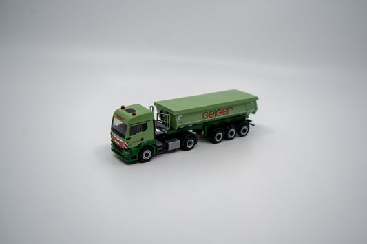 Miniaturmodell eines Mercedes Geiger-LKW in Geiger-Grün mit grauem Thermomulden Anhänger mit rotem "Geiger" Schriftzug. Verpackung inklusive.